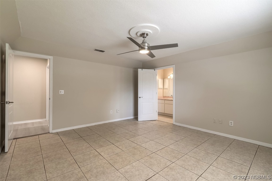 2311 Pine Tree Drive Edgewater, FL 32141 - Photo 17 of 32 a view of an empty room and chandelier fan