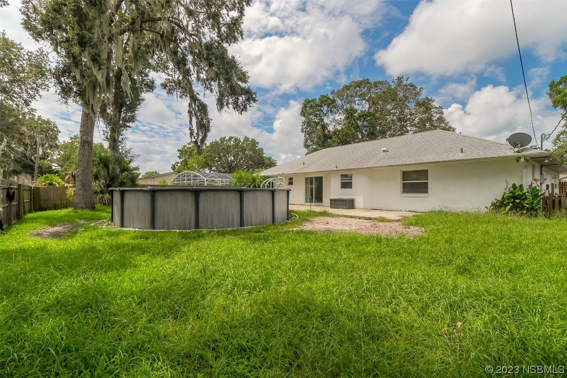 2311 Pine Tree Drive Edgewater, FL 32141 - Photo 22 of 32 a view of a house with backyard and garden