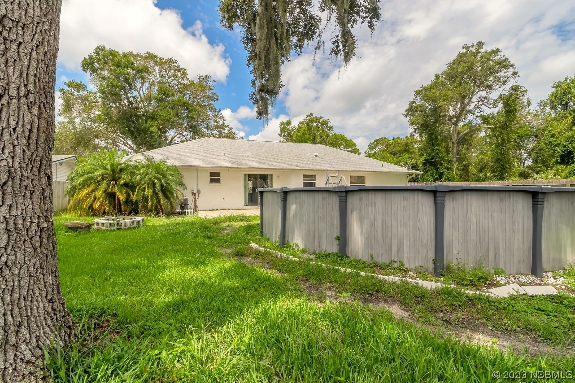 2311 Pine Tree Drive Edgewater, FL 32141 - Photo 23 of 32 a view of a house with a yard and sitting area