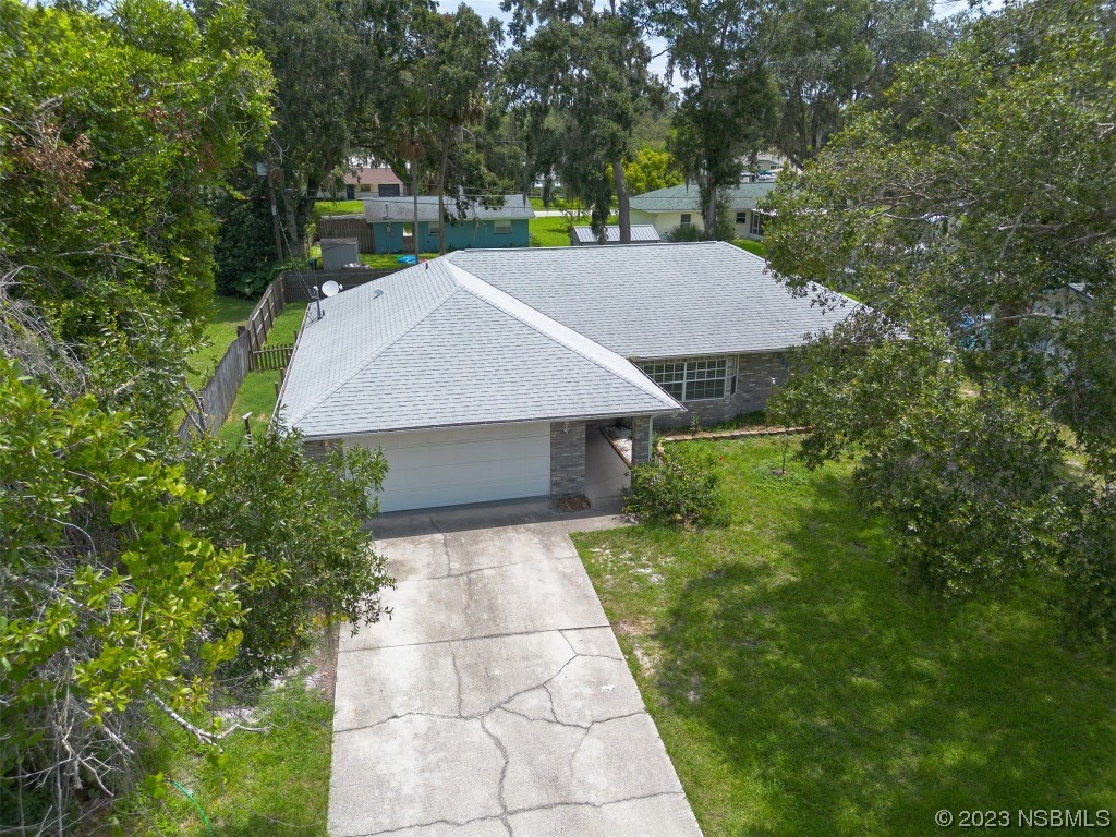2311 Pine Tree Drive Edgewater, FL 32141 - Photo 25 of 32 a view of a yard in front of a house with a yard