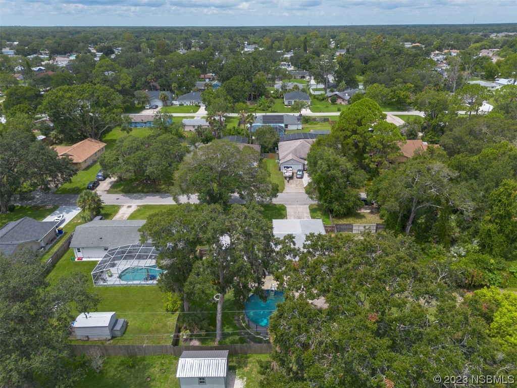 2311 Pine Tree Drive Edgewater, FL 32141 - Photo 29 of 32 an aerial view of residential houses with outdoor space and trees
