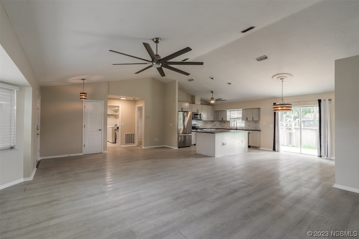 2311 Pine Tree Drive Edgewater, FL 32141 - Photo 6 of 32 a view of a kitchen with a refrigerator and a stove top oven