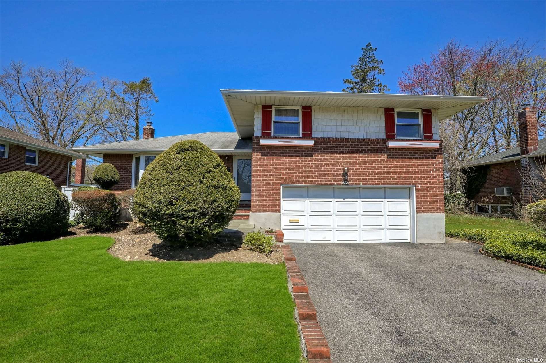 77 Phipps Lane Plainview, NY 11803 - Photo 1 of 1 a front view of a house with a yard