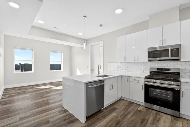 a kitchen with stainless steel appliances granite countertop a stove and a sink
