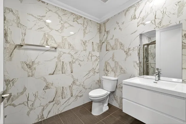 a bathroom with a toilet sink and shower