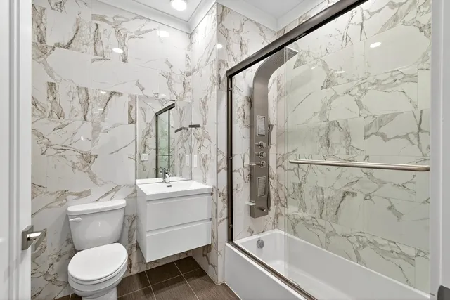 a bathroom with a sink toilet and shower