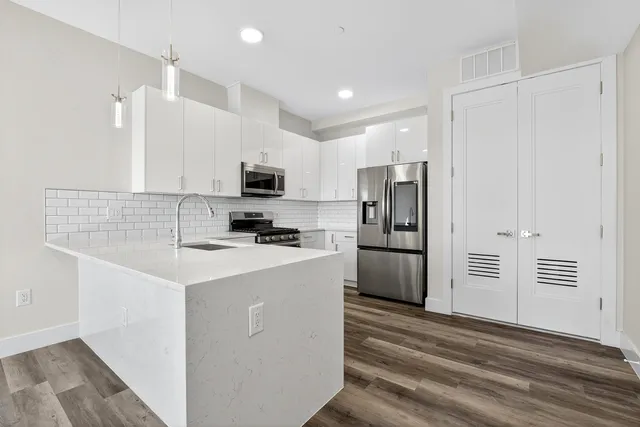 a kitchen with stainless steel appliances a refrigerator stove and microwave