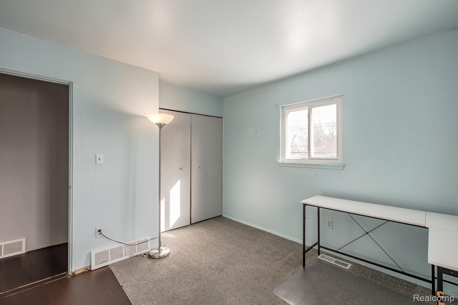 8670 North Eston Road Clarkston, MI 48348 - Photo 13 of 29 Unfurnished bedroom featuring carpet floors and a closet