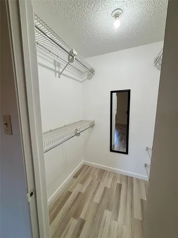 a view of a room with wooden floor
