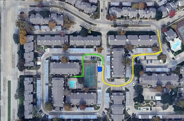 a view of an empty room with wooden floor and a fireplace