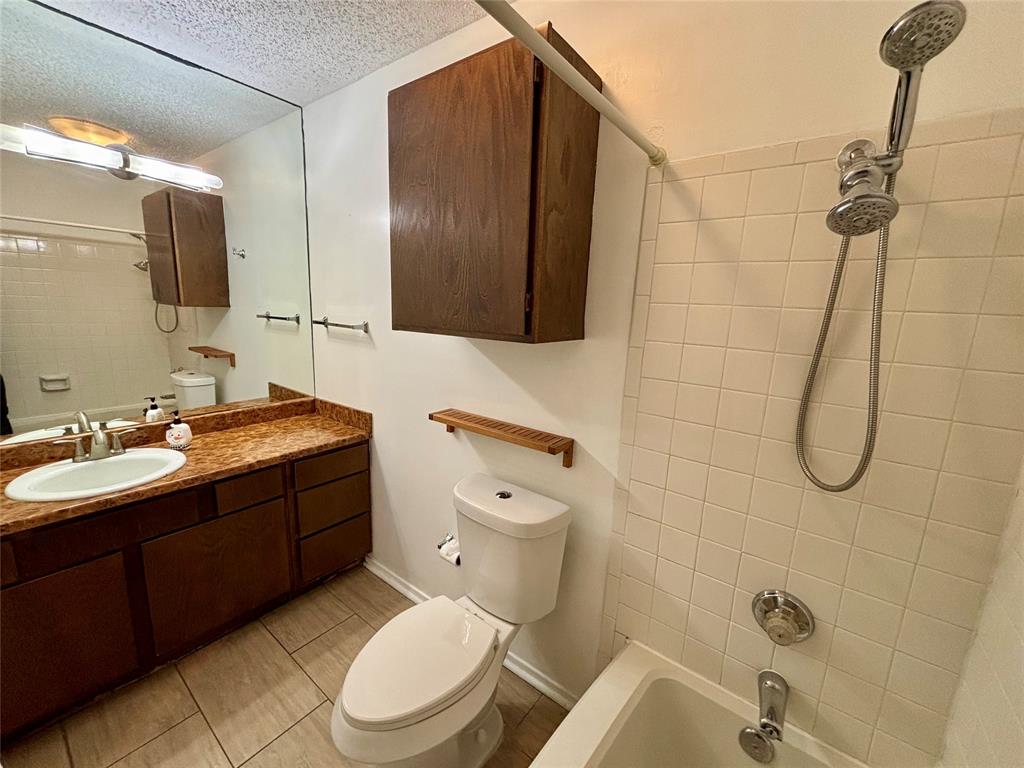 12480 Abrams Road, Unit 2805 Dallas, TX 75243 - Photo 9 of 18 a bathroom with a sink a toilet and shower