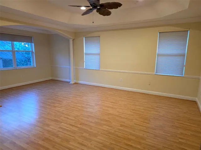 wooden floor in an empty room with a window