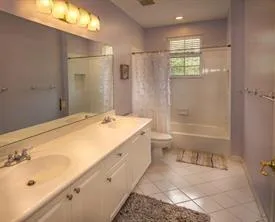 a spacious bathroom with a granite countertop sink a toilet and shower