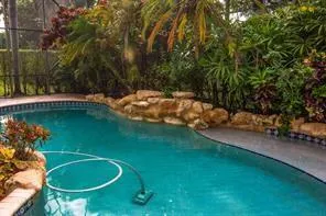 a view of a backyard with swimming pool