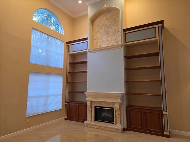 a view of an empty room with a fireplace and a window
