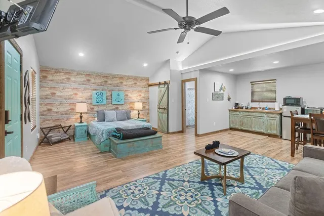 a living room with furniture and kitchen view