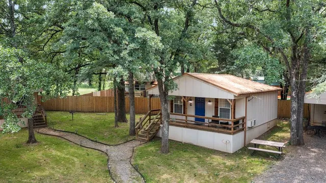 an aerial view of a house with swimming pool and a yard