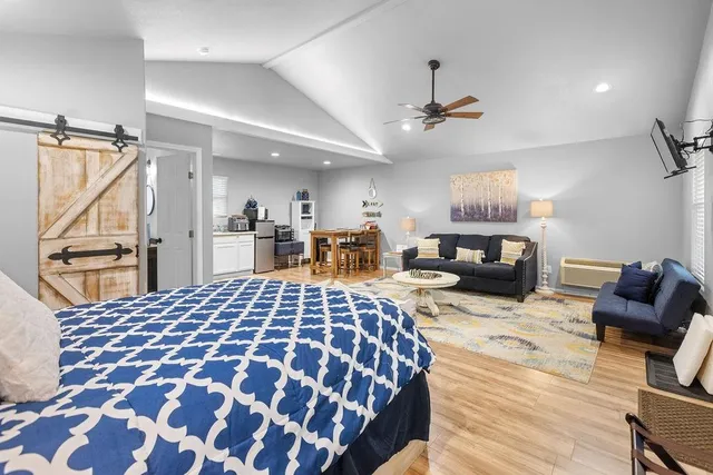 a bedroom with a bed and wooden floor