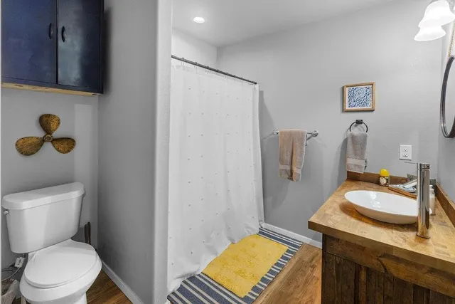 a bathroom with a sink toilet and shower