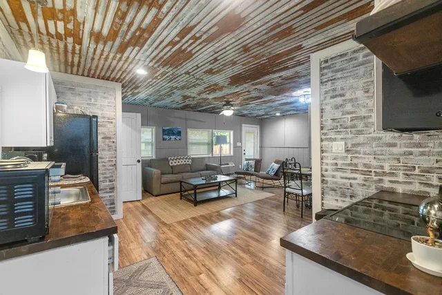 a kitchen with sink stove and refrigerator