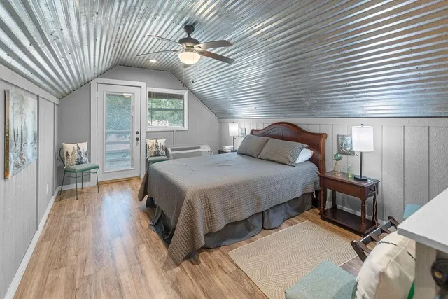 a bedroom with a bed and a large window