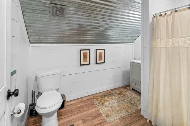 a bathroom with a toilet and a shower