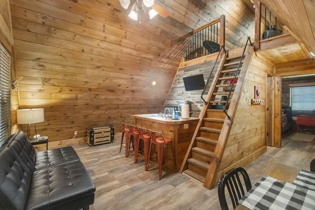a view of a patio with table and chairs with wooden floor and fence