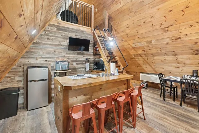 a view of a kitchen with furniture and wooden floor