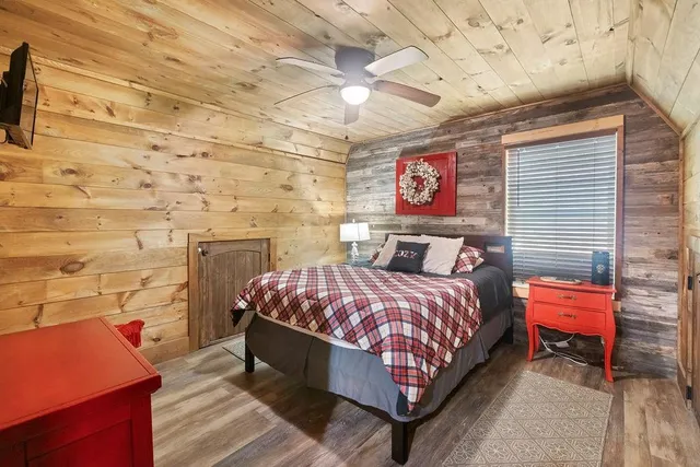 a bed room with a bed and a chair