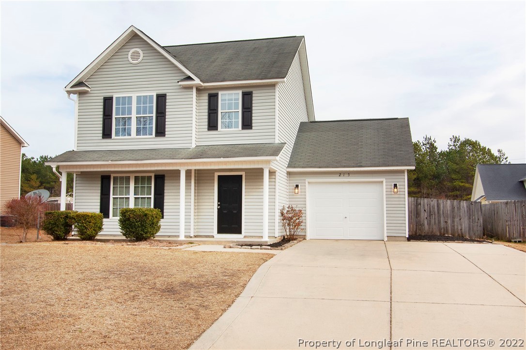 215 Cape Fear Road Raeford, NC 28376 - Photo 1 of 24 a front view of a house with a yard and garage
