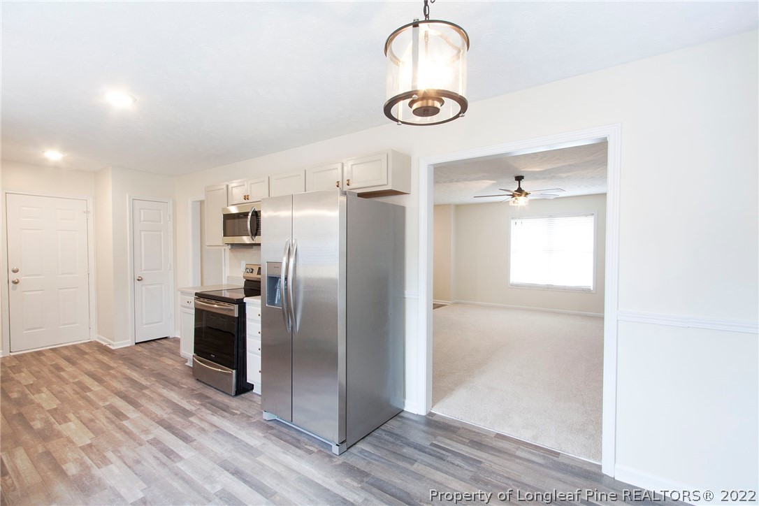 215 Cape Fear Road Raeford, NC 28376 - Photo 11 of 24 a kitchen with stainless steel appliances granite countertop a refrigerator and a sink