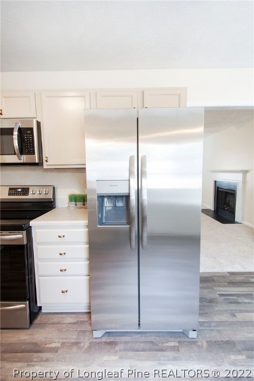 215 Cape Fear Road Raeford, NC 28376 - Photo 12 of 24 a kitchen with a refrigerator and a stove
