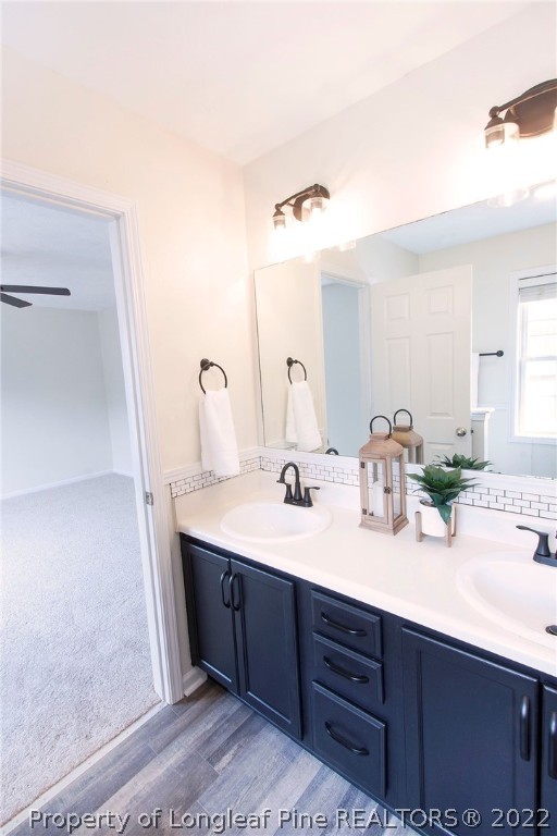 215 Cape Fear Road Raeford, NC 28376 - Photo 18 of 24 a bathroom with a double vanity sink and a mirror
