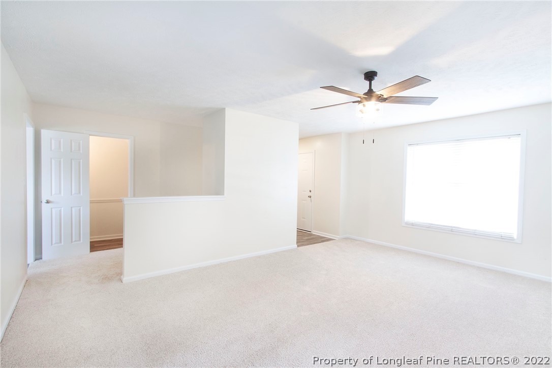 215 Cape Fear Road Raeford, NC 28376 - Photo 3 of 24 an empty room with a window and a ceiling fan