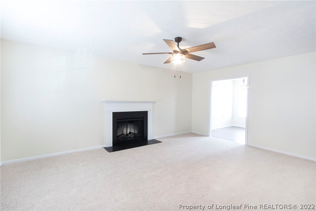 215 Cape Fear Road Raeford, NC 28376 - Photo 4 of 24 a view of empty room with a fireplace