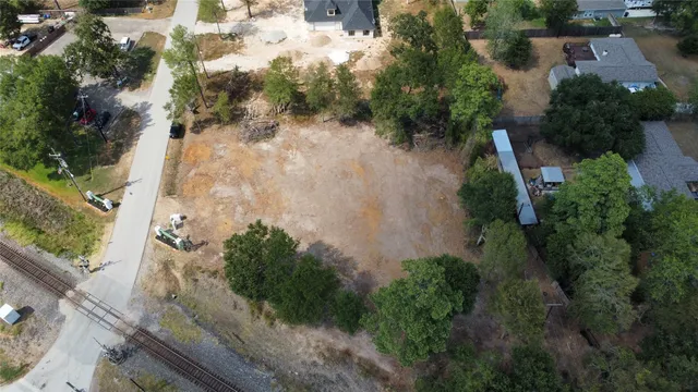 an aerial view of residential house with outdoor space and trees all around