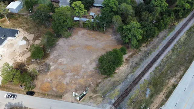 a view of a yard with plants and a bench