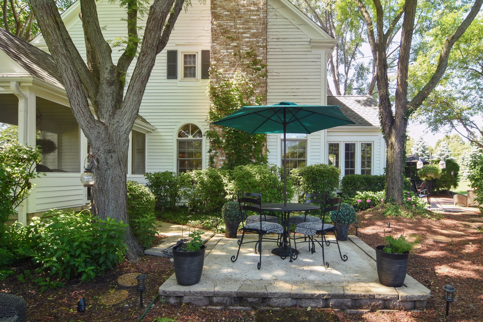 20755 North Weatherstone Road Kildeer, IL 60047 - Photo 42 of 61 a view of a patio with table and chairs under an umbrella