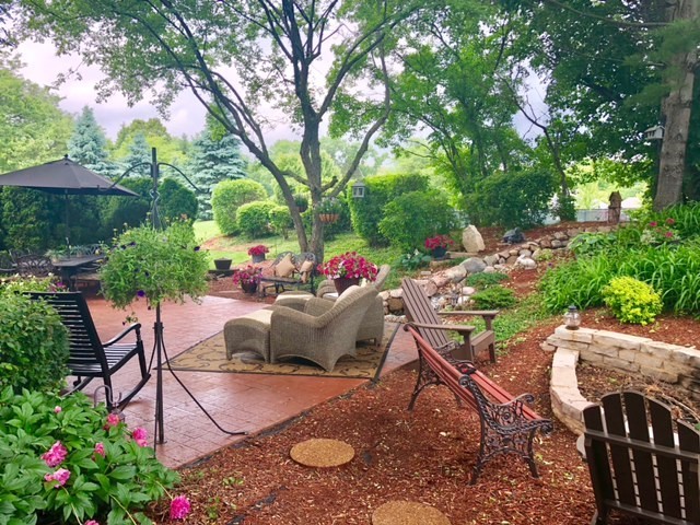 20755 North Weatherstone Road Kildeer, IL 60047 - Photo 45 of 61 a view of a patio with table and chairs potted plants and large tree