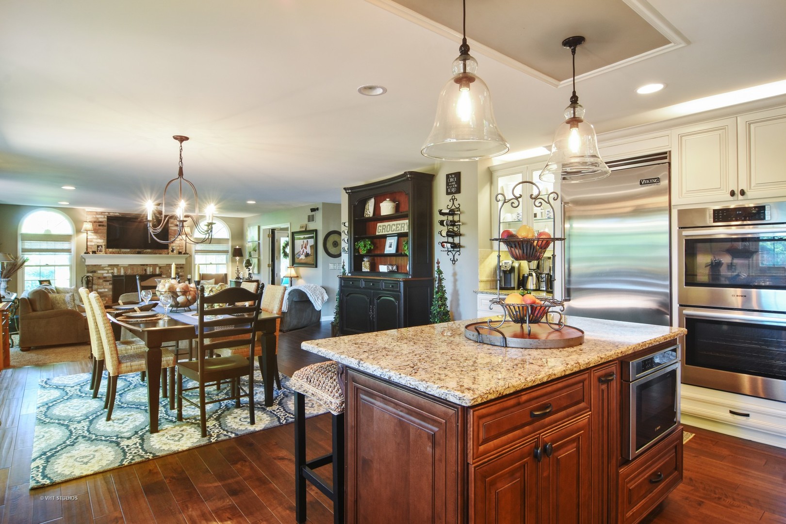 20755 North Weatherstone Road Kildeer, IL 60047 - Photo 8 of 61 a kitchen with stainless steel appliances kitchen island granite countertop a table chairs and a refrigerator