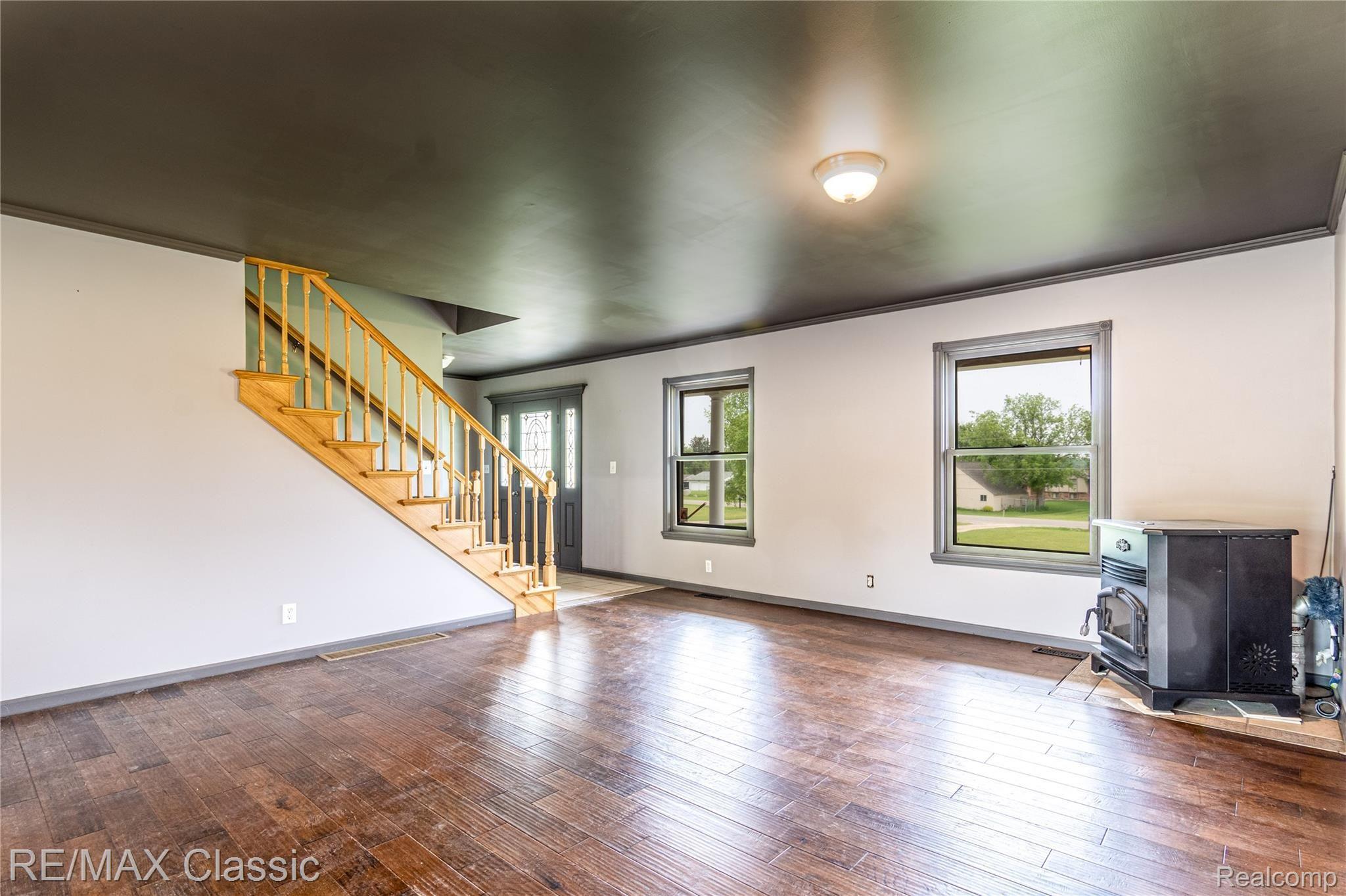 5765 Stanley Road Columbiaville, MI 48421 - Photo 4 of 40 Entry and living room, wood burner