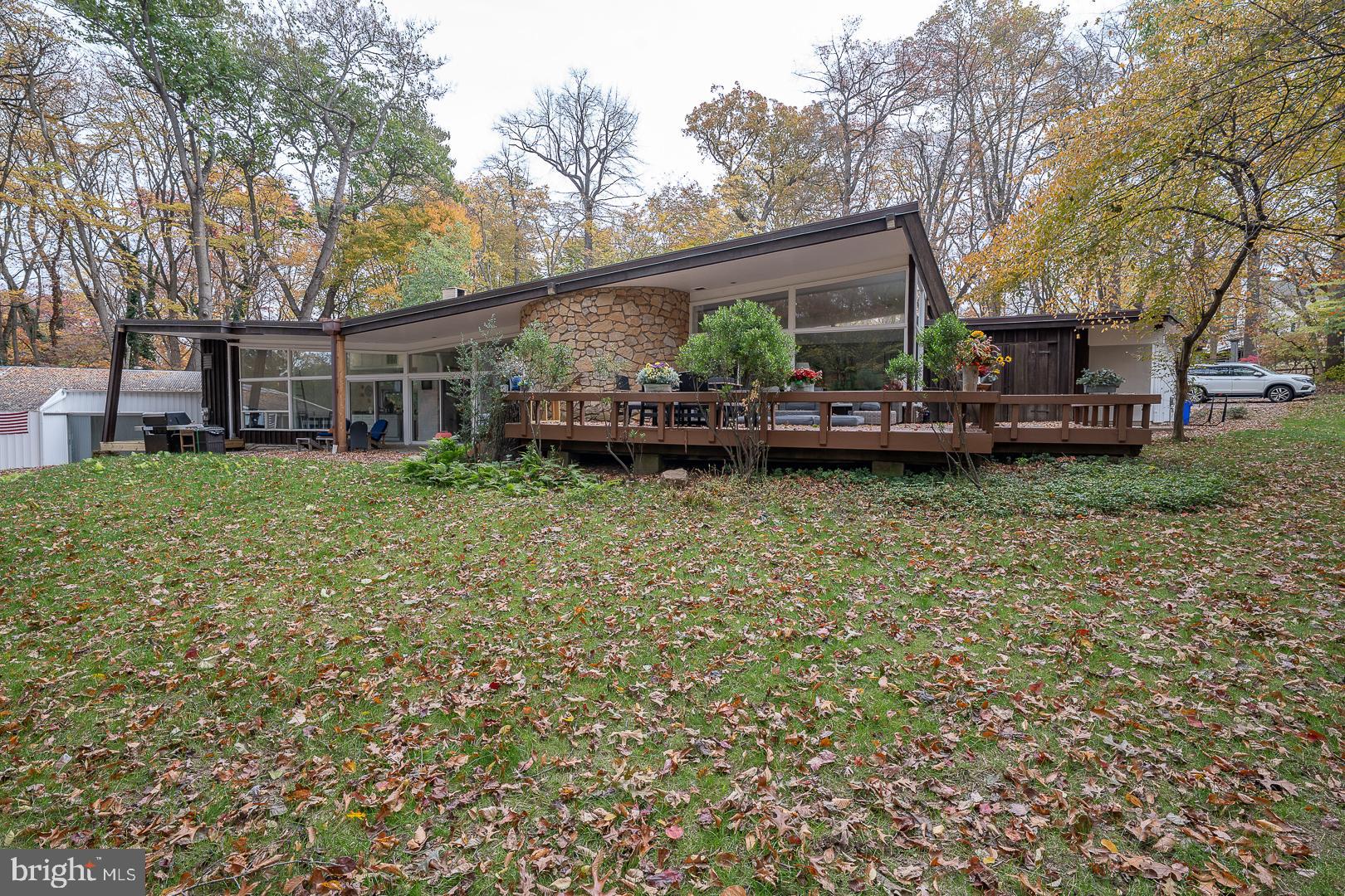 a view of a house with a yard and sitting area
