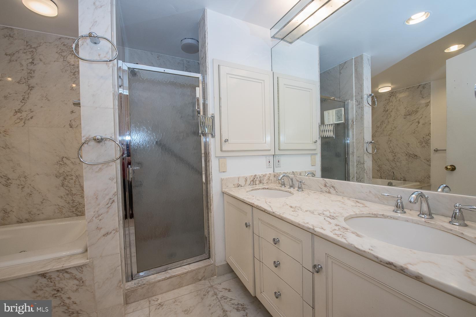 39 Fairview Road Penn Valley, PA 19072 - Photo 11 of 20 a bathroom with a granite countertop sink mirror and shower