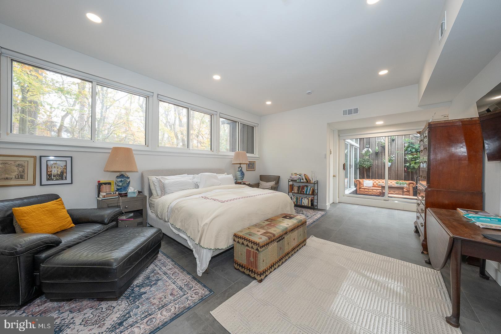 39 Fairview Road Penn Valley, PA 19072 - Photo 10 of 20 a spacious bedroom with a bed a couch and a flat tv screen on dresser