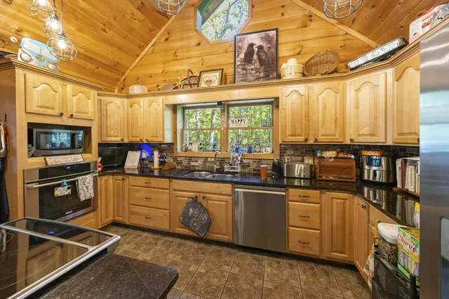 a kitchen with stainless steel appliances granite countertop a stove and a refrigerator