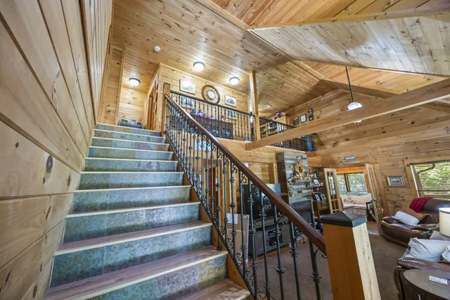 a view of a hallway with wooden floor and furniture