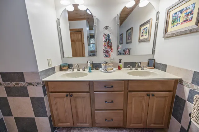 a balcony view with couple of chairs and wooden fence