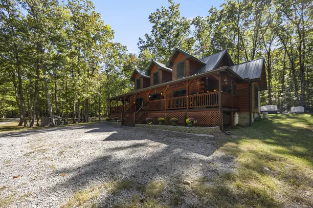 a view of a house with a swimming pool and sitting area