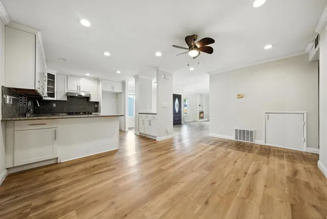 a view of kitchen with refrigerator microwave and stove