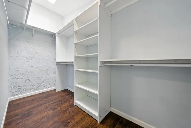 a view of walk in closet with empty racks